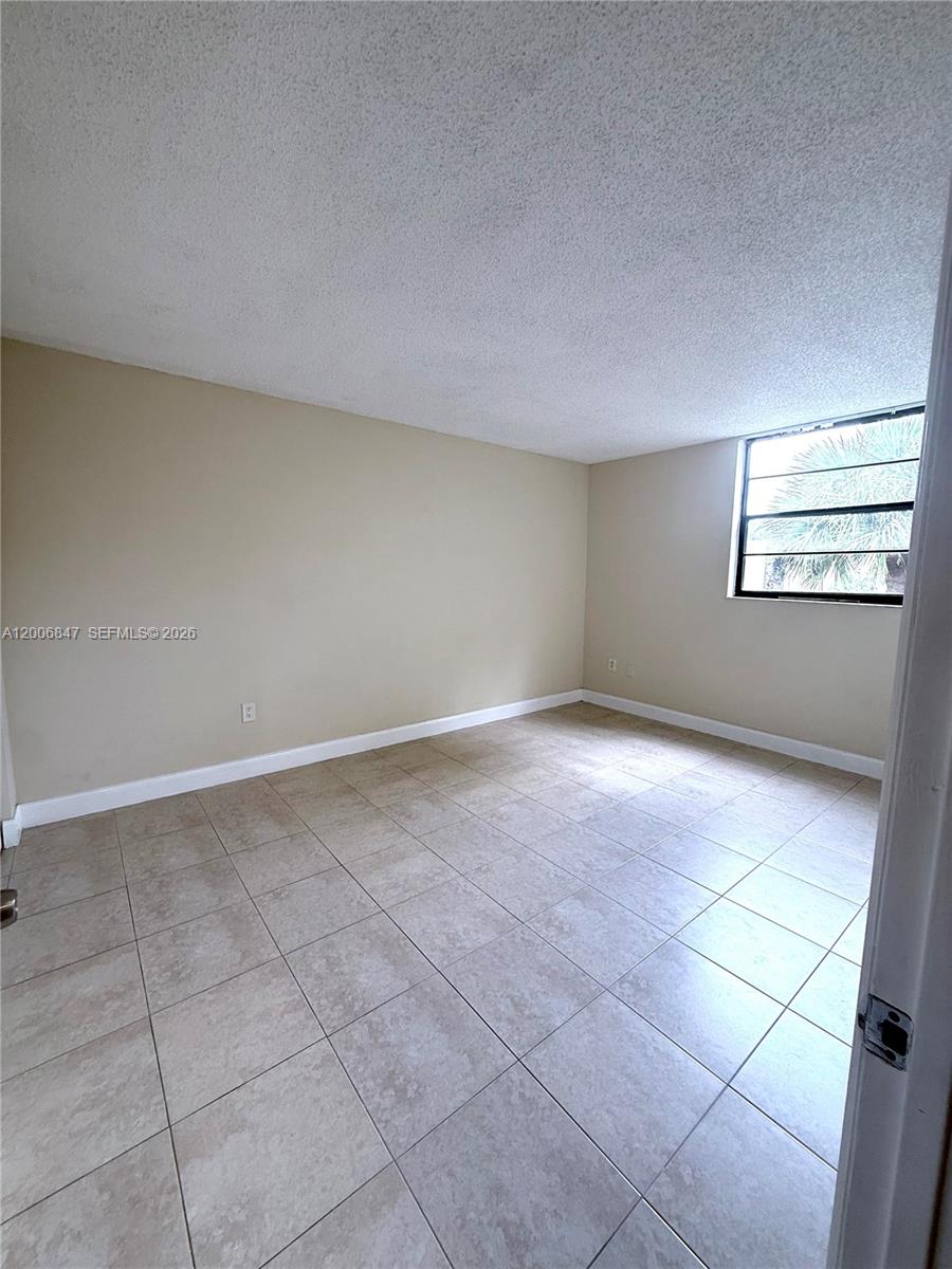 10835 Southwest 112th Avenue, Unit 306 Miami, FL 33176 - Photo 16 of 19 a view of an empty room with a window