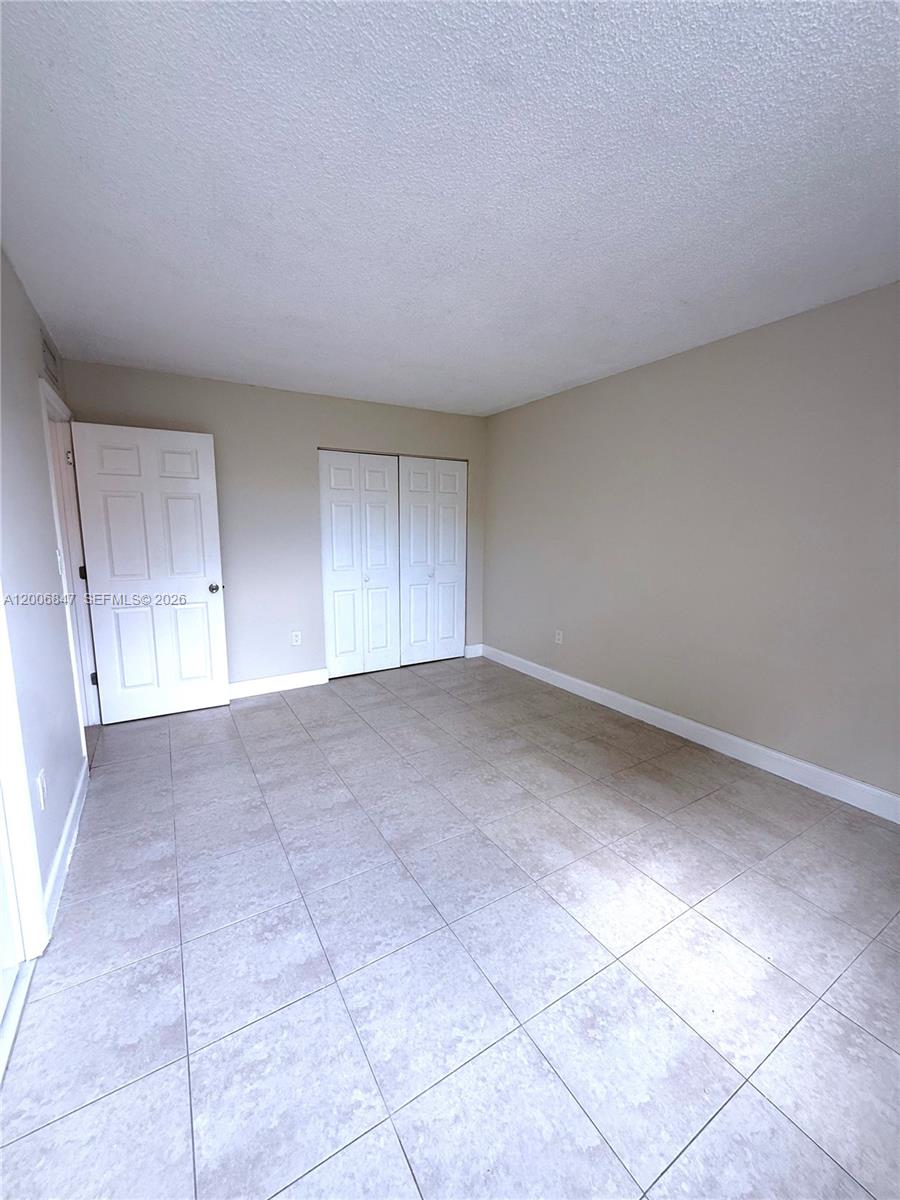 10835 Southwest 112th Avenue, Unit 306 Miami, FL 33176 - Photo 17 of 19 an empty room with a natural light