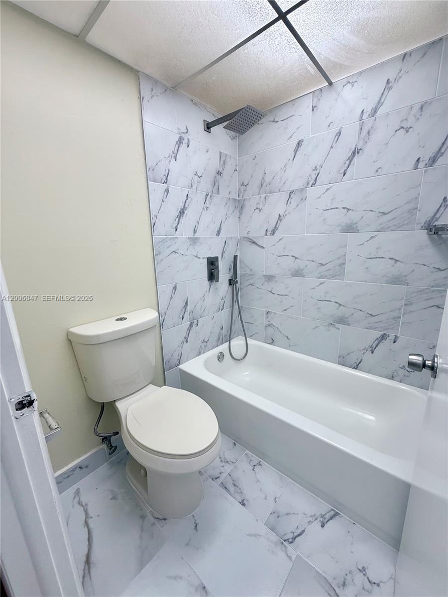 10835 Southwest 112th Avenue, Unit 306 Miami, FL 33176 - Photo 19 of 19 a white toilet sitting next to a bath tub