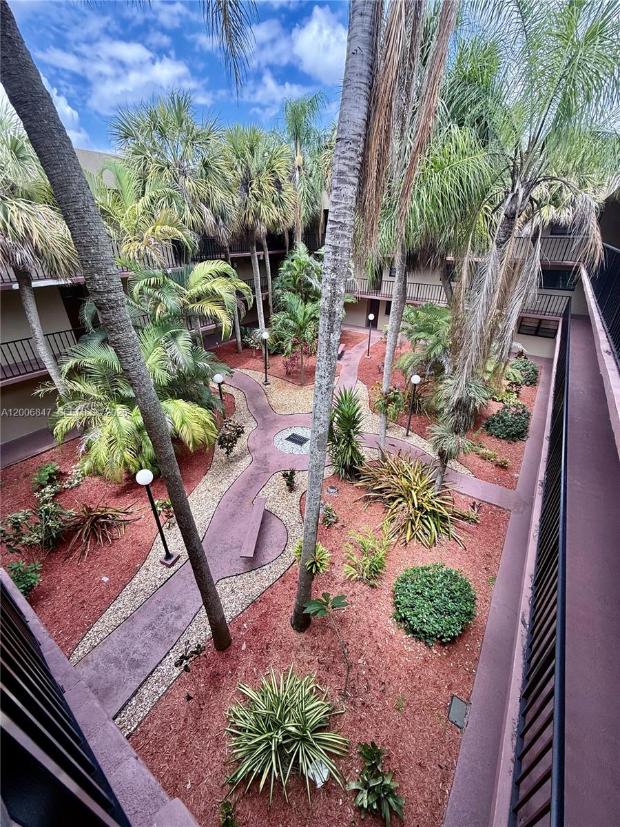 10835 Southwest 112th Avenue, Unit 306 Miami, FL 33176 - Photo 2 of 19 a backyard of a house with lots of green space