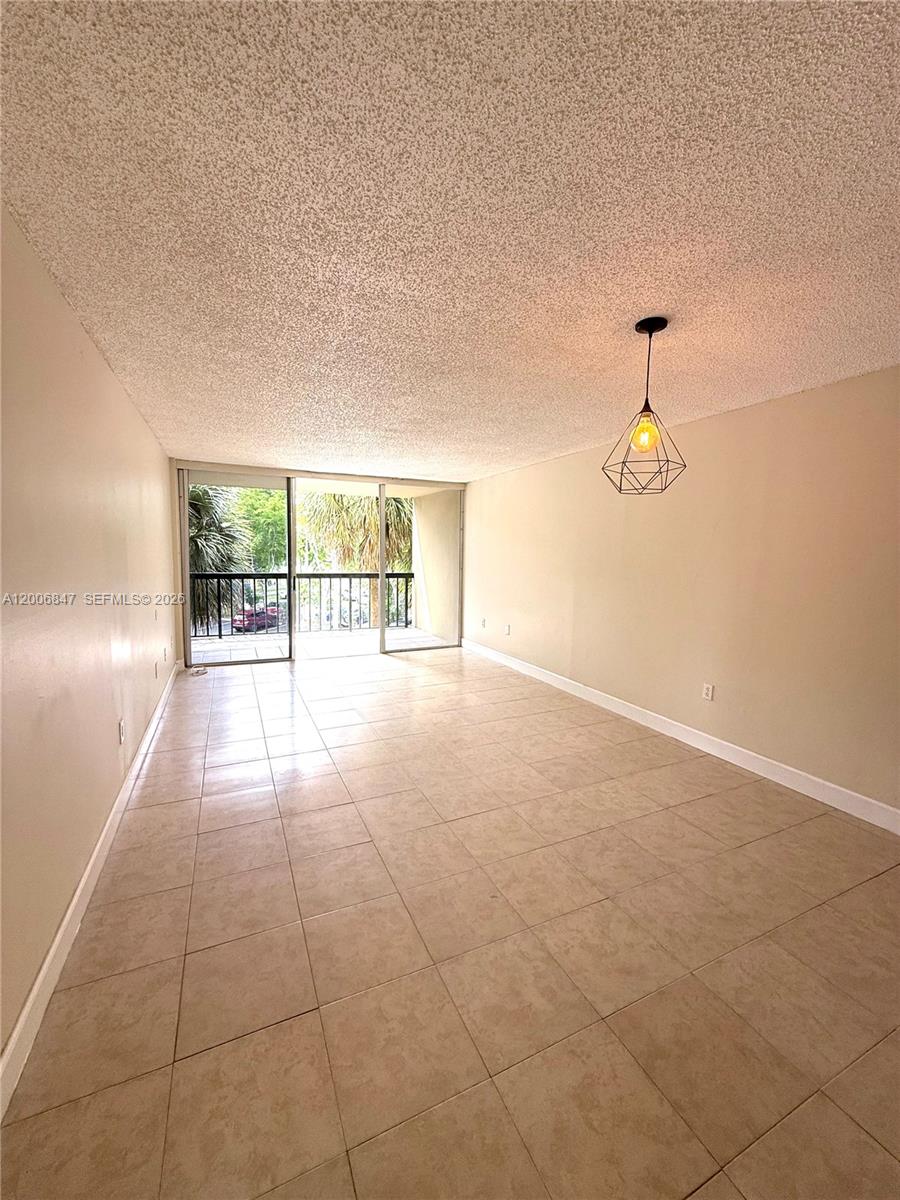 10835 Southwest 112th Avenue, Unit 306 Miami, FL 33176 - Photo 5 of 19 a view of an empty room with glass door