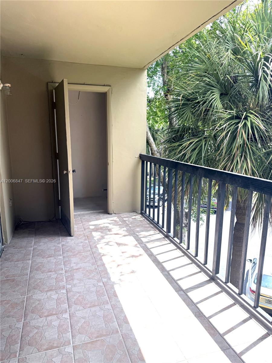 10835 Southwest 112th Avenue, Unit 306 Miami, FL 33176 - Photo 9 of 19 a balcony with wooden floor