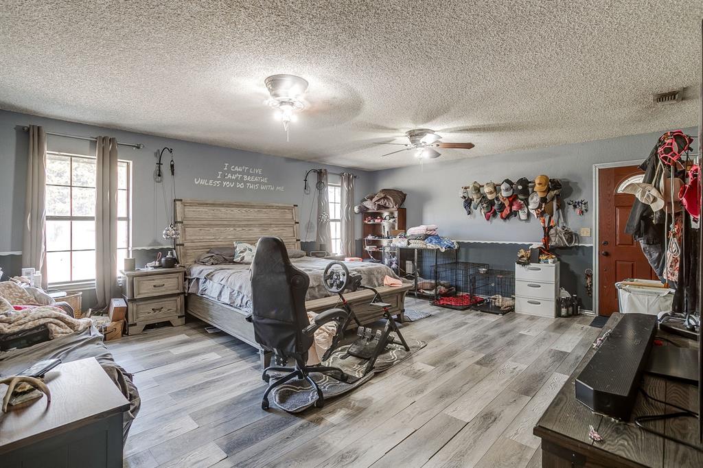 4763 Blue Flat Road Gordon, TX 76453 - Photo 11 of 40 a living room with furniture a flat screen tv and a large window