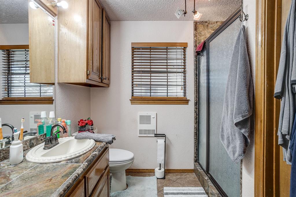4763 Blue Flat Road Gordon, TX 76453 - Photo 14 of 40 a bathroom with a sink and a mirror
