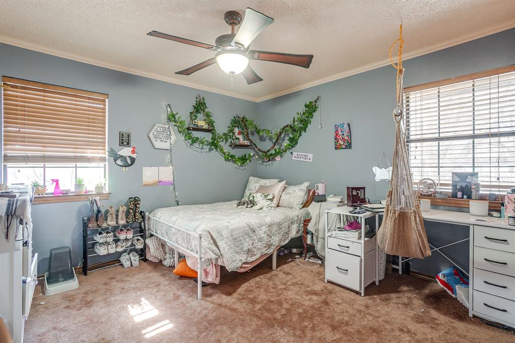 4763 Blue Flat Road Gordon, TX 76453 - Photo 15 of 40 a bedroom with a bed table chair and window