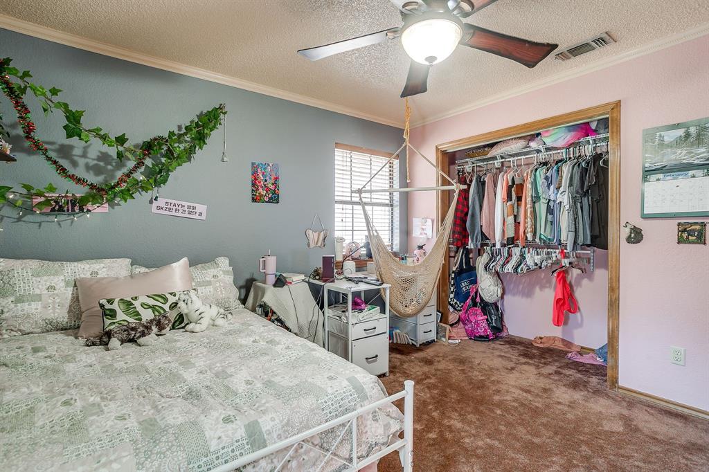 4763 Blue Flat Road Gordon, TX 76453 - Photo 16 of 40 a bedroom with a bed and a walk in closet