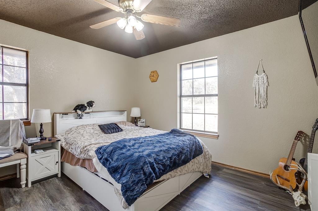 4763 Blue Flat Road Gordon, TX 76453 - Photo 18 of 40 a bedroom with bed and window