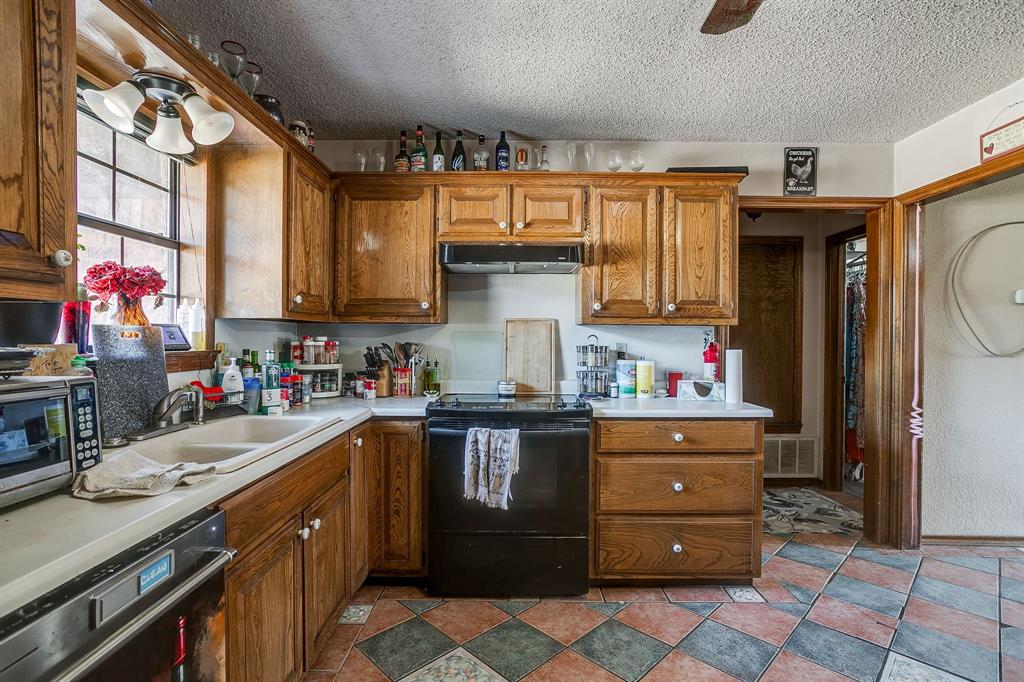 4763 Blue Flat Road Gordon, TX 76453 - Photo 9 of 40 a kitchen with a sink cabinets and window
