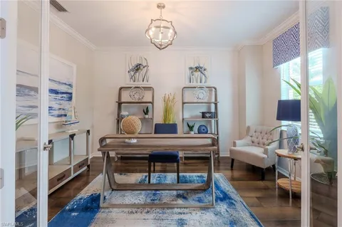 a living room with furniture a rug and wooden floor