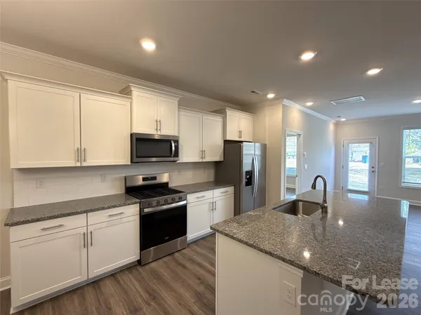 a kitchen with a sink stove and refrigerator
