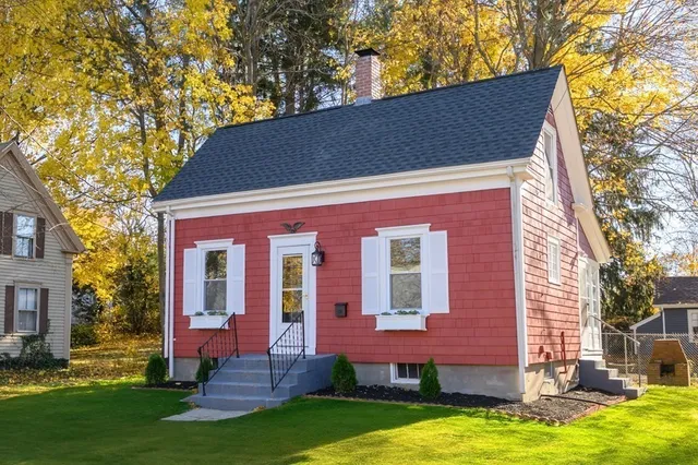 a backyard of a house with yard table and chairs