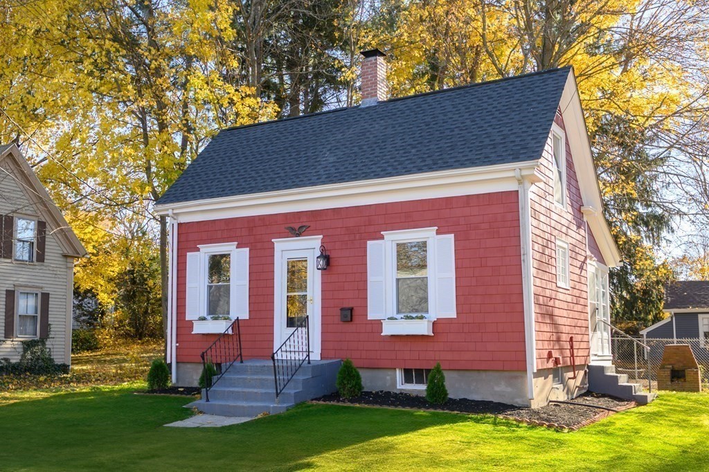 a backyard of a house with yard table and chairs