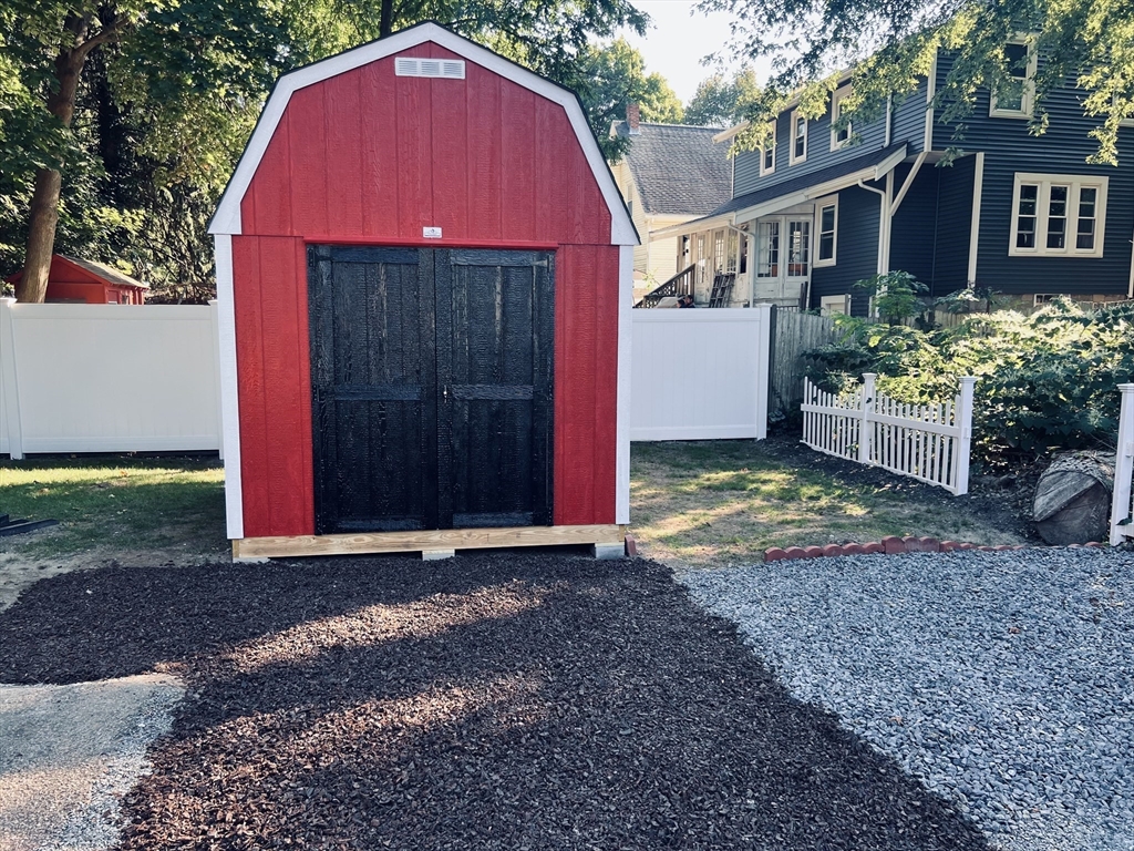 9 Bank Street Abington, MA 02351 - Photo 3 of 16 a view of a small house with a small yard and large tree