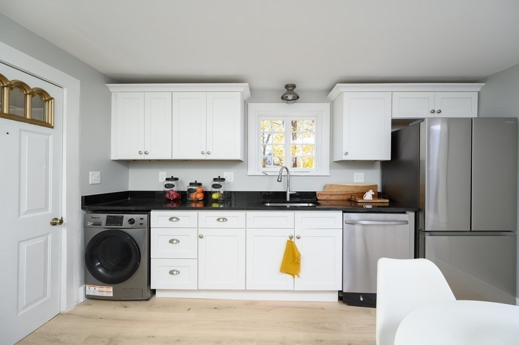 9 Bank Street Abington, MA 02351 - Photo 6 of 16 a kitchen with a sink a stove and cabinets