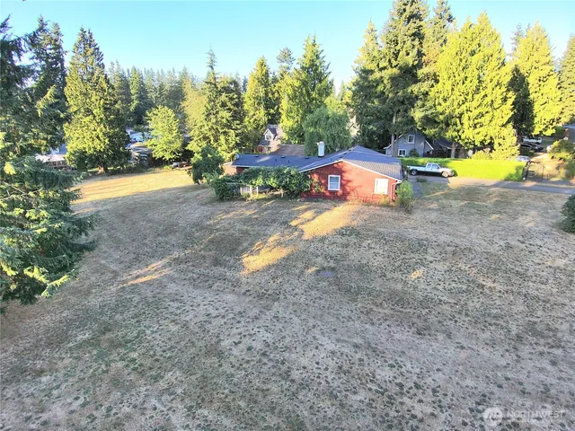 an aerial view of a house with a yard