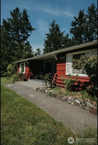 a view of house with a yard and entertaining space