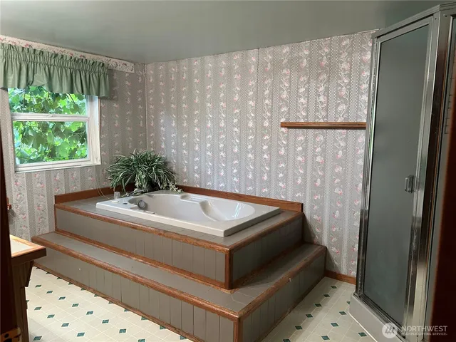 a bathroom with a tub and shower