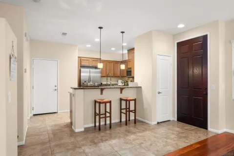 a kitchen with kitchen island white cabinets and stainless steel appliances