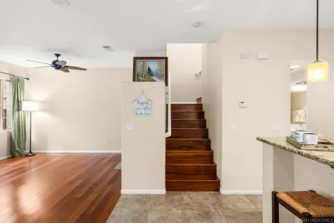 a view of a hallway with a large mirror and a dresser