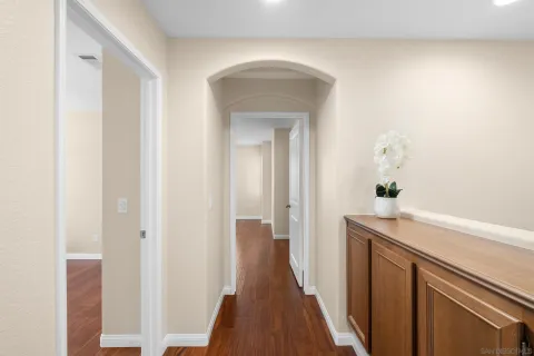 a view of a hallway view with wooden floor and staircase