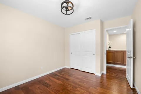 a view of a room with wooden floor