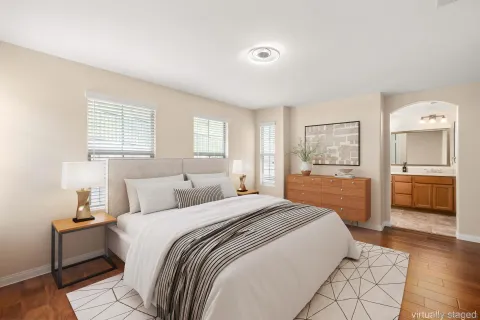 a bedroom with a bed and a view of kitchen