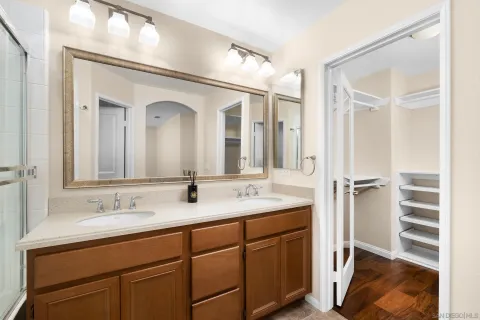 a bathroom with a double vanity sink and a mirror