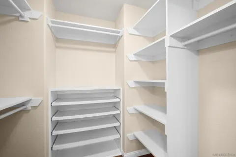 a view of walk in closet with empty racks