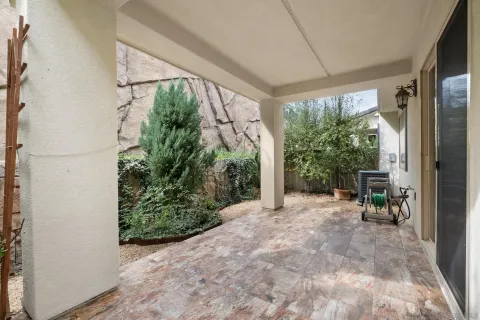 a view of backyard with plants and outdoor seating
