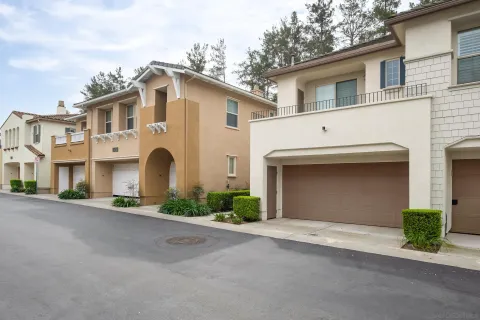 a view of a white house with a street