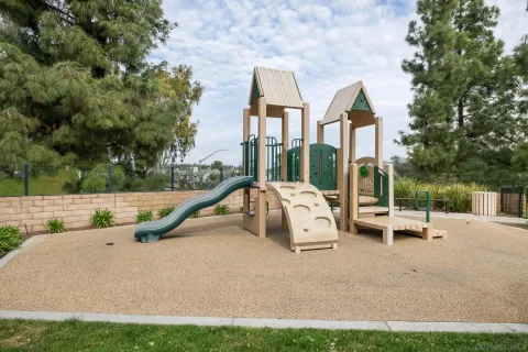 a view of backyard with swimming pool and seating space
