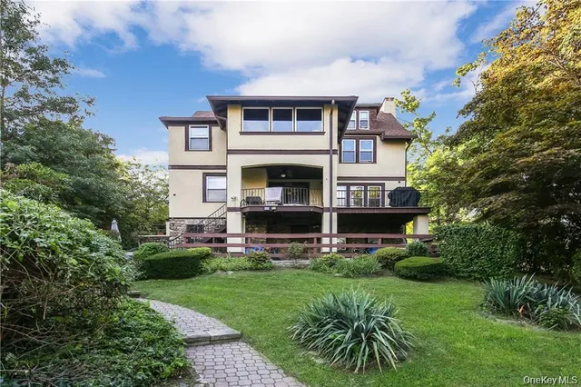 a front view of a house with a garden and plants
