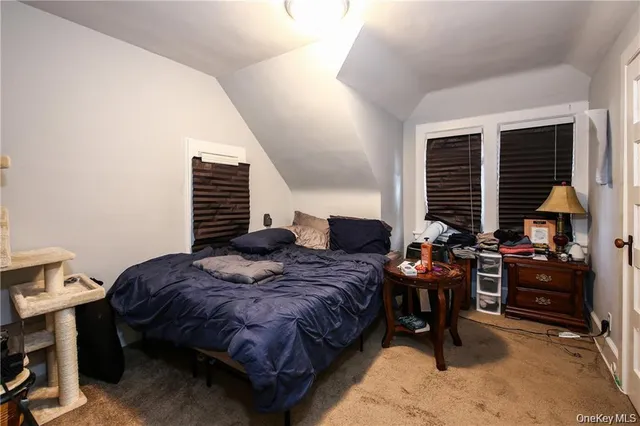 a bedroom with bed and a window