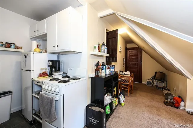 a kitchen with a sink a stove and cabinets