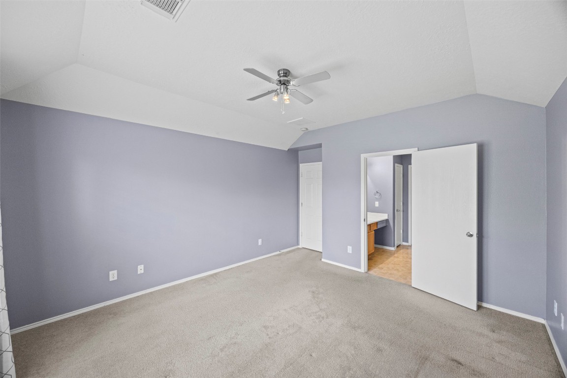 9510 Barr Spring Drive Humble, TX 77396 - Photo 17 of 27 an empty room with closet and a ceiling fan