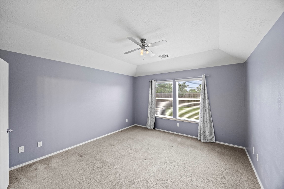 9510 Barr Spring Drive Humble, TX 77396 - Photo 18 of 27 an empty room with a empty space and a ceiling fan