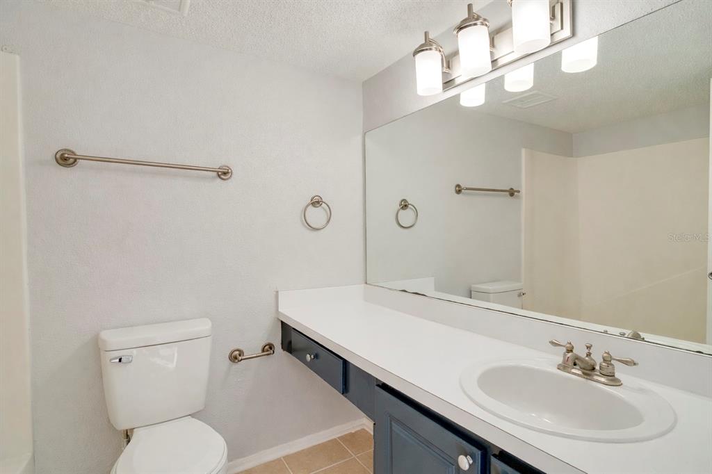 129 Blue Pointe Way, Unit 340 Altamonte Springs, FL 32701 - Photo 13 of 25 a bathroom with a sink a toilet a mirror and shower