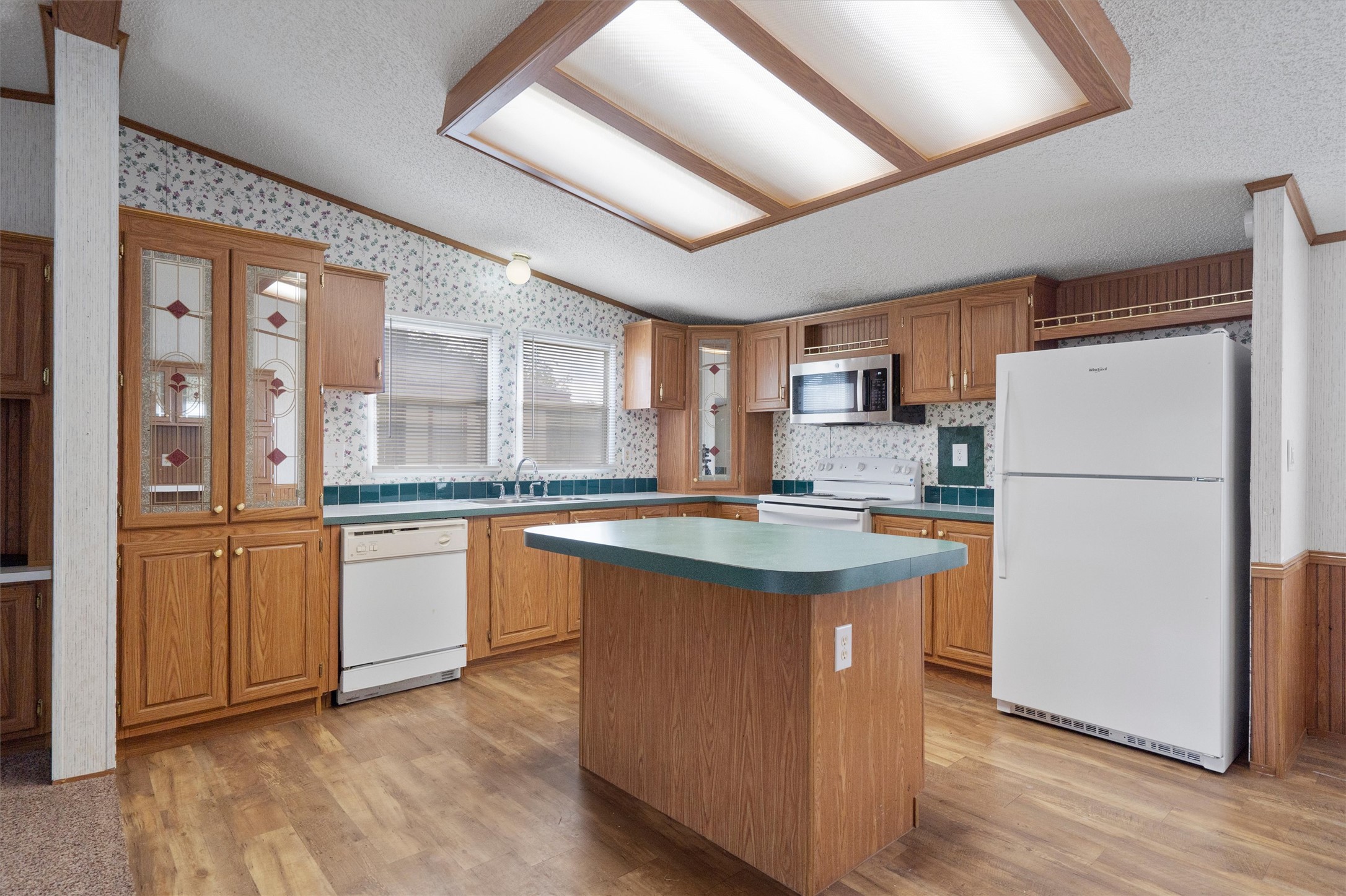 3075 Old Black Colony Road, Unit D Buda, TX 78610 - Photo 7 of 26 Warm wood cabinetry and a central island ground this functional kitchen workspace.