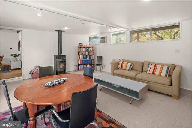 a living room with a table and chairs