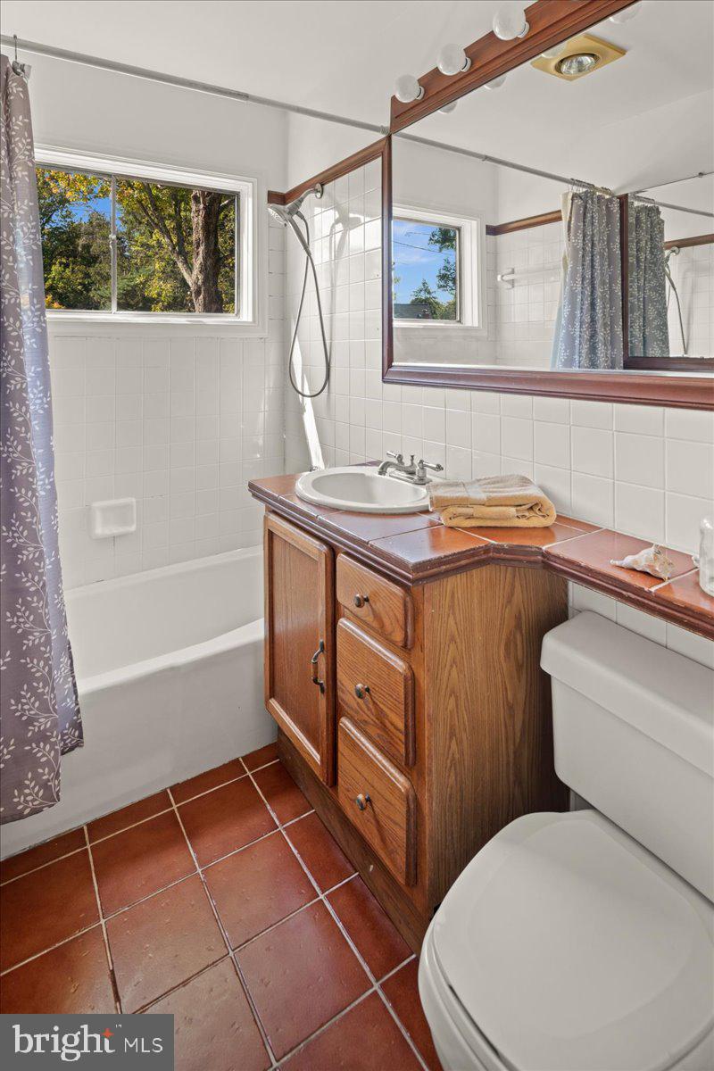 75 Clover Lane Princeton, NJ 08540 - Photo 20 of 37 a bathroom with a granite countertop sink a toilet and bathtub