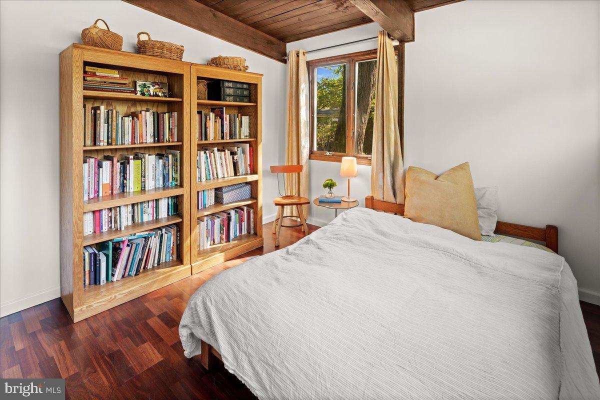 75 Clover Lane Princeton, NJ 08540 - Photo 22 of 37 a bedroom with a bed a book shelf and a book shelf