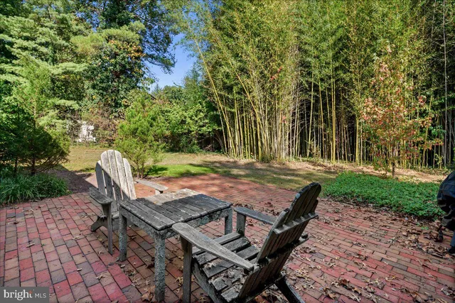 a view of a wooden dinning table and chairs in patio