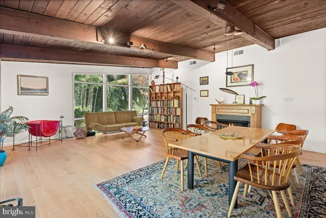 a dining room with a wooden table and chairs