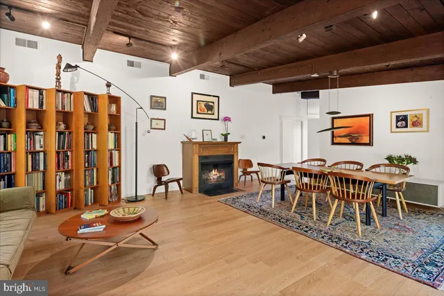 a living room with furniture a fireplace and a table