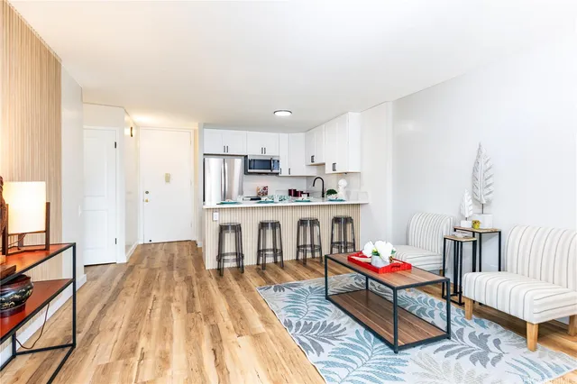 a living room with kitchen island furniture and a wooden floor