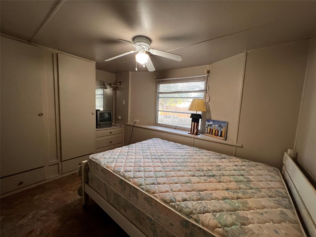 1036 Paradise Cove Road Pottsboro, TX 75076 - Photo 11 of 40 a bedroom with a bed and a chandelier