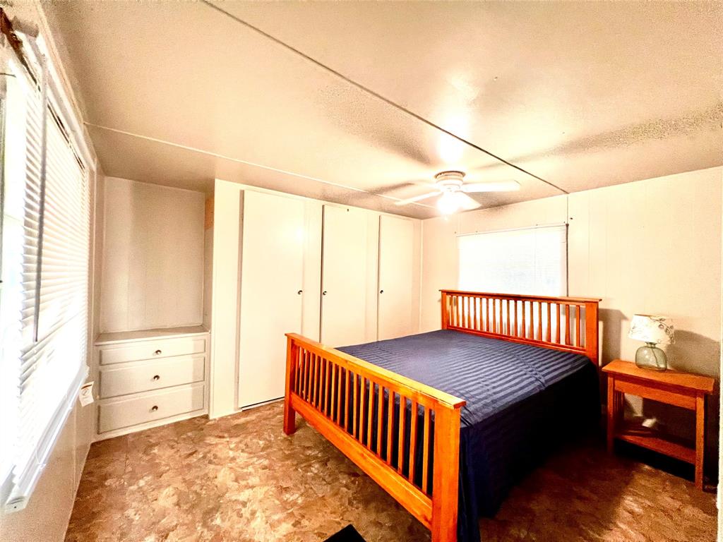 1036 Paradise Cove Road Pottsboro, TX 75076 - Photo 18 of 40 a view of a bedroom with furniture and wooden floor