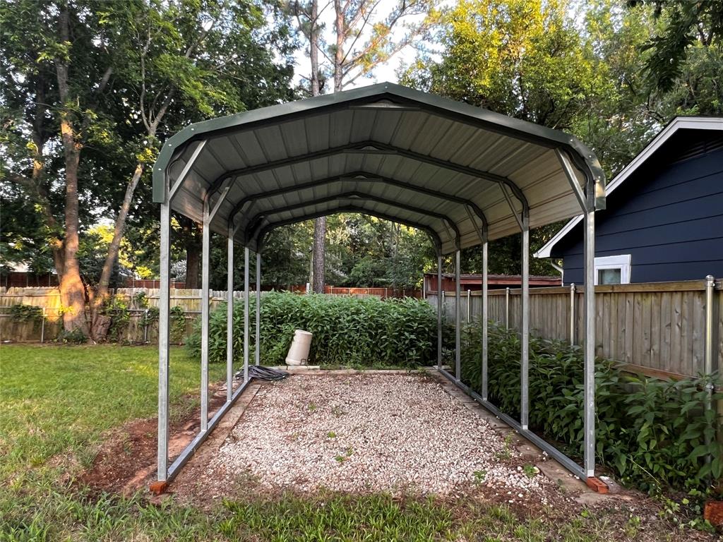 1036 Paradise Cove Road Pottsboro, TX 75076 - Photo 19 of 40 a view of a small house with a small yard plants and large trees