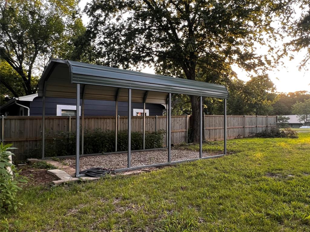 1036 Paradise Cove Road Pottsboro, TX 75076 - Photo 29 of 40 a backyard of a house with plants and large tree