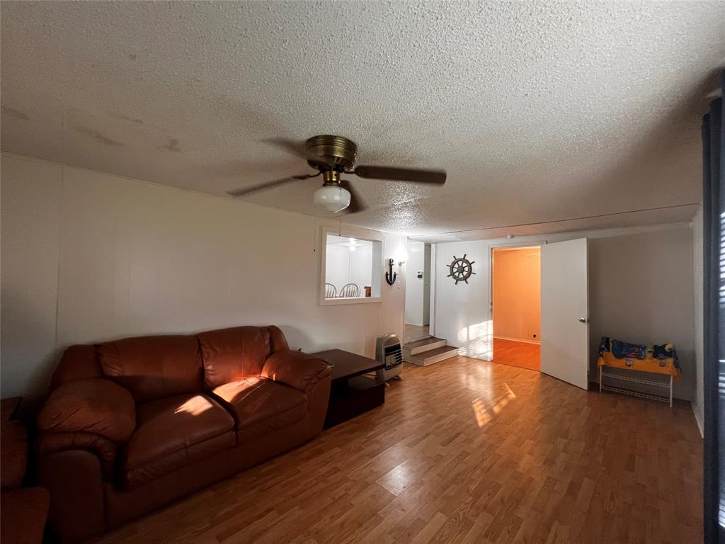 1036 Paradise Cove Road Pottsboro, TX 75076 - Photo 35 of 40 a living room with furniture and a wooden floor